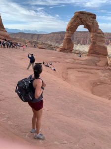Kelly from Our Adventure Journal at Delicate Arch in Arches National Park in Utah