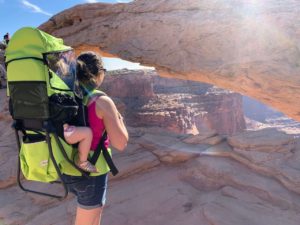 Woman and baby at Mesa Arch using the Clevr child carrier, one of the best baby travel products
