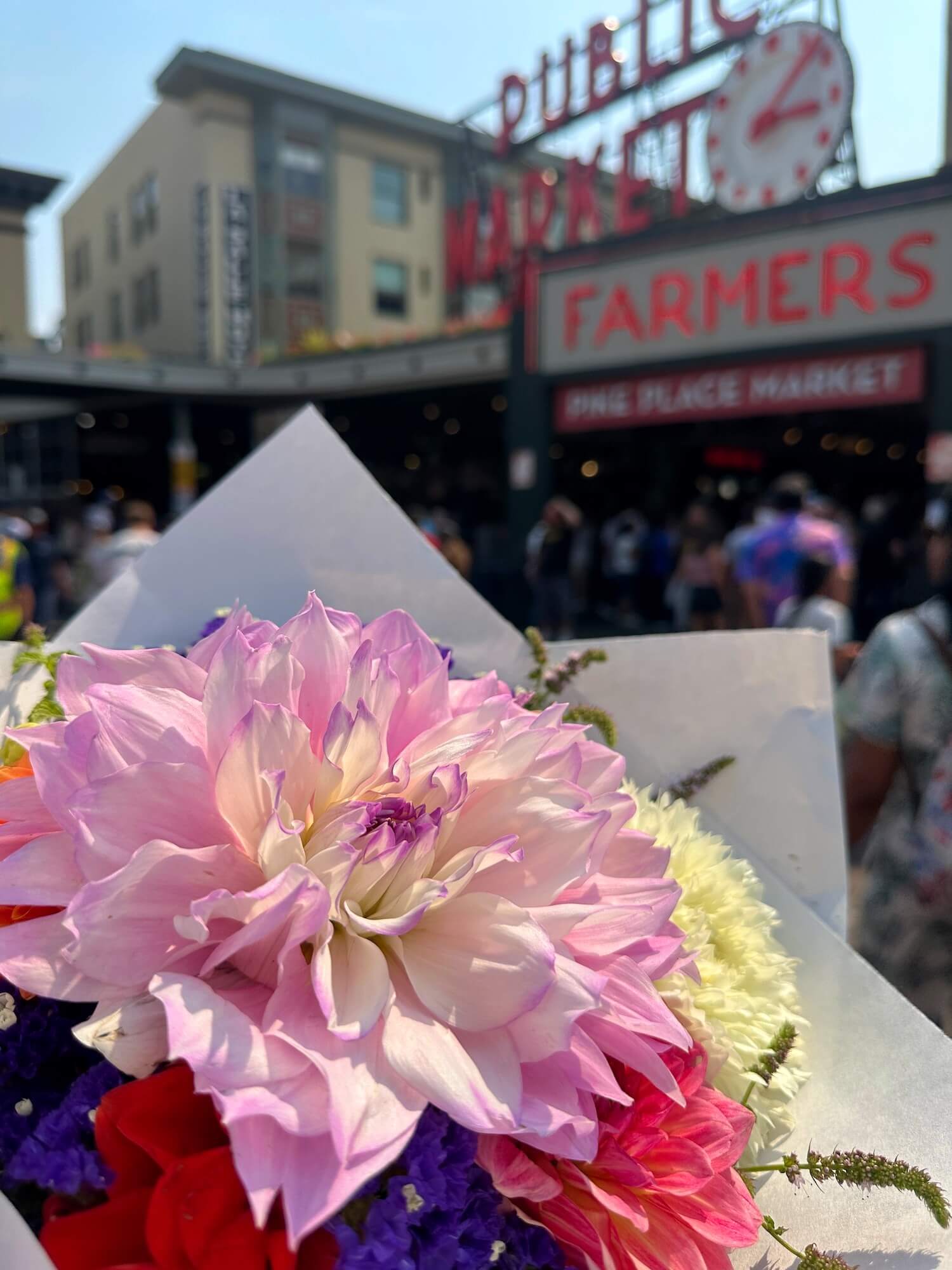 Bouquet of flowers in front of Pike Place Market sign