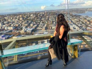 Kelly from Our Adventure Journal sitting on a skyriser at the Space Needle