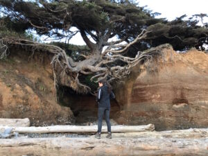 Kelly from Our Adventure Journal visiting the Tree of Life in Washington at Kalaloch Beach