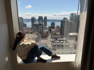 Room view from Hyatt Regency Seattle, with Kelly from Our Adventure Journal sitting in the window frame